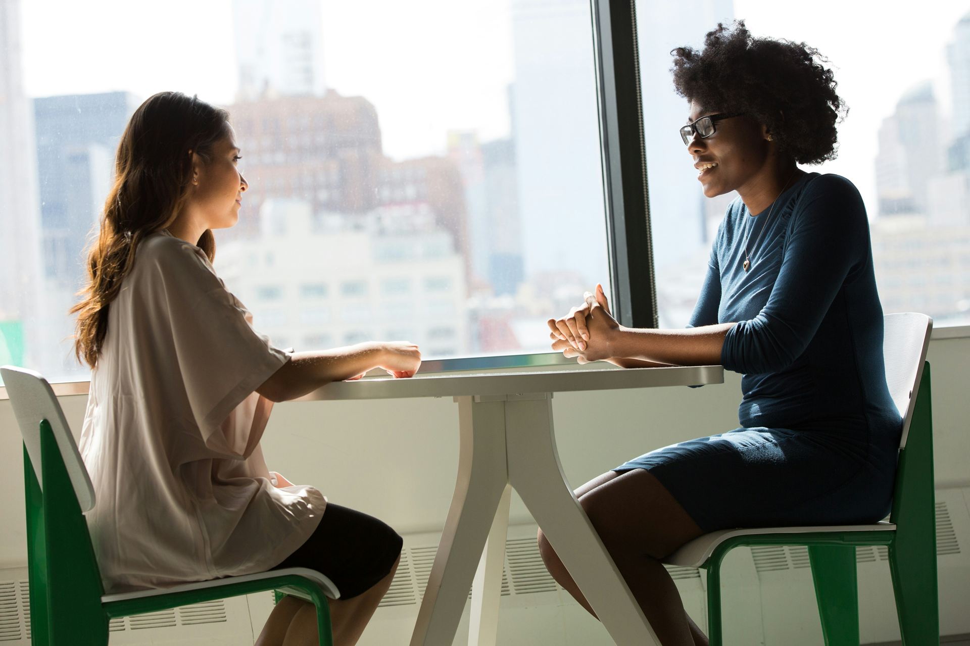 Two people talking at a table